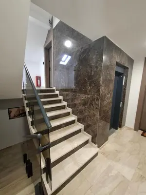 a staircase in a building with a marble wall at Stef Lux Apartments in Belgrade