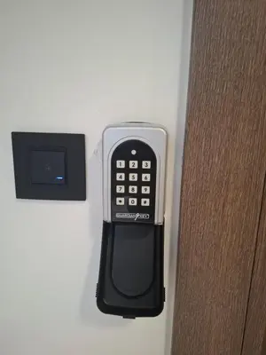 a cell phone is attached to the side of a door at Stef Lux Apartments in Belgrade