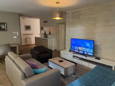 a living room with a couch and a flat screen tv at Malvex in Belgrade