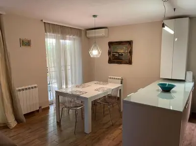 a kitchen with a table with chairs and a counter top at Malvex in Belgrade