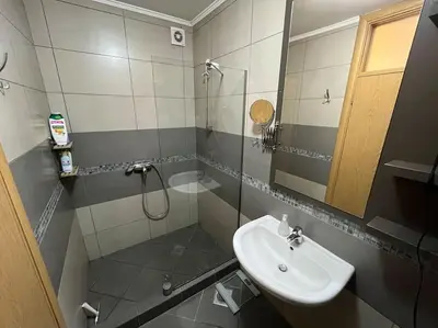 a bathroom with a sink and a shower with a mirror at Malvex in Belgrade