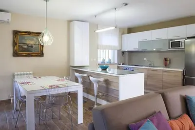 a kitchen and living room with a table and a couch at Malvex in Belgrade