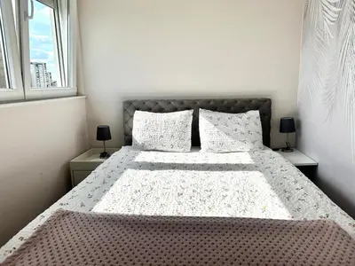 a white bedroom with a large bed with pillows at Golden Sunset Terrace Apartment Ana in Belgrade
