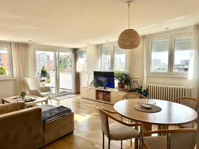 a living room with a table and a couch at Golden Sunset Terrace Apartment Ana in Belgrade