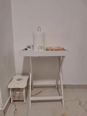 a white table with a roll of paper towels on it at Toni apartment in Belgrade