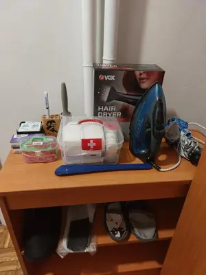 a table with a hair dryer and a telephone at Toni apartment in Belgrade