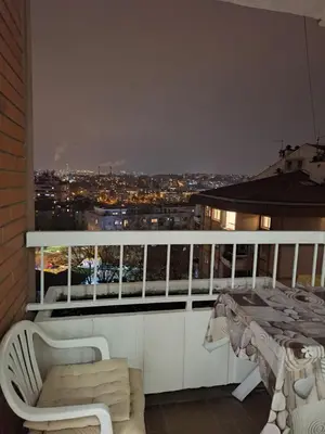 a balcony with a view of a city at night at Toni apartment in Belgrade