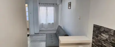 a living room with a couch and a window at Kristian 1 in Belgrade