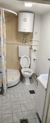 a bathroom with a toilet and a tub and a sink at Kristian 1 in Belgrade