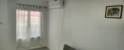 a white room with a window with a white curtain at Kristian 1 in Belgrade