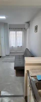 a living room with a couch and a window at Kristian 1 in Belgrade