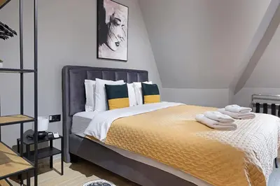 a bedroom with a bed with towels on it at Apartment Paradise Slavija Tres in Belgrade