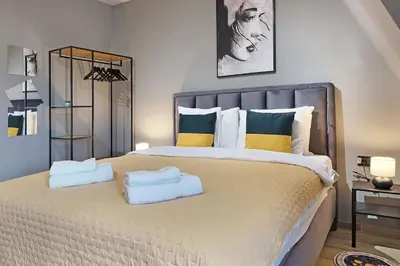 a bedroom with a large bed with two towels on it at Apartment Paradise Slavija Tres in Belgrade
