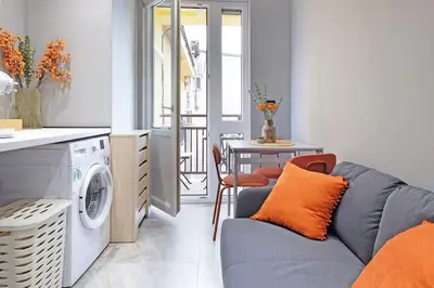 a living room with a couch and a washing machine at Apartment Paradise Slavija Tres in Belgrade