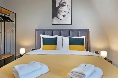 a bedroom with a large bed with towels on it at Apartment Paradise Slavija Tres in Belgrade