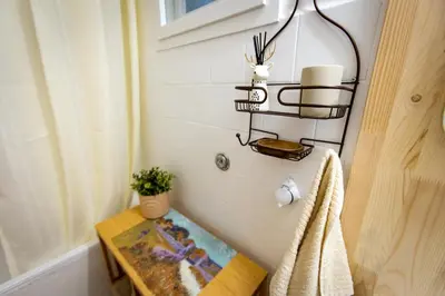 a bathroom with a table and a towel at Lule garden apartment in Belgrade