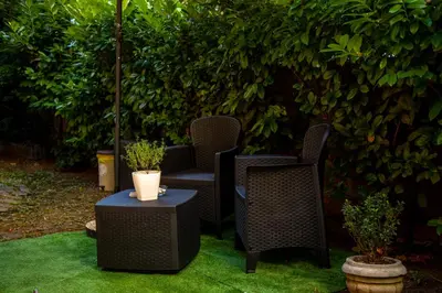a group of chairs and a table on the grass at Lule garden apartment in Belgrade