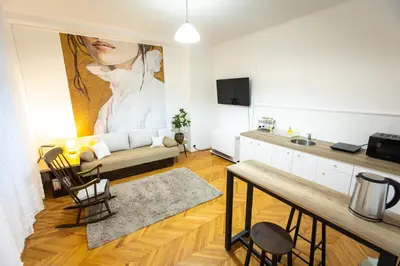 a living room with a large painting of a woman at Lule garden apartment in Belgrade