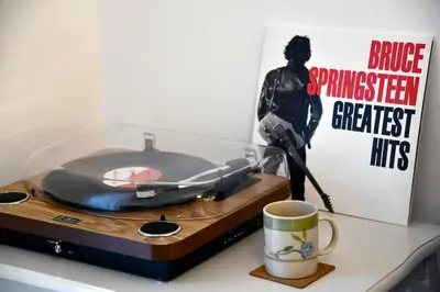 a record player on a counter next to a coffee mug at Present Perfect Stay in Belgrade
