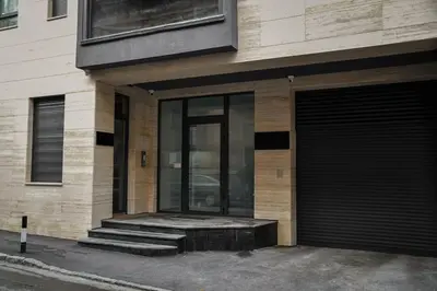 a building with a glass door and stairs on it at Present Perfect Stay in Belgrade