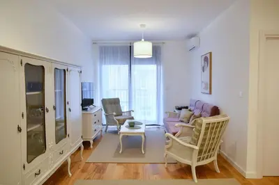 a living room with a couch and chairs at Present Perfect Stay in Belgrade