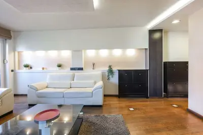a living room with a white couch and a table at Emma in Belgrade