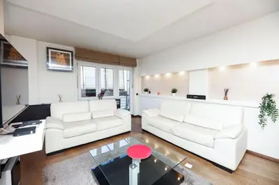 a living room with two white couches and a table at Emma in Belgrade