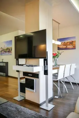 a living room with a television and a table with chairs at Emma in Belgrade