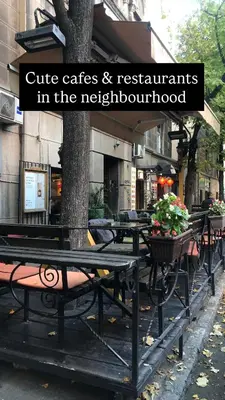 a group of tables and benches on a city street at Oblak in Belgrade