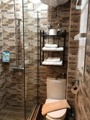a bathroom with a toilet and a glass shower at Oblak in Belgrade