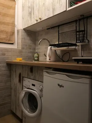 a laundry room with a washing machine and a sink at Oblak in Belgrade