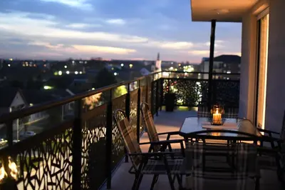 a balcony with a table and chairs with a view at Loft 43 in Stara Pazova