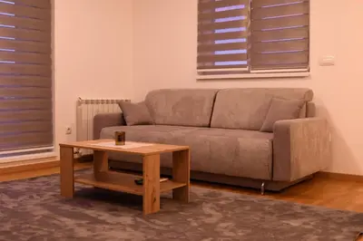 a living room with a couch and a coffee table at Loft 43 in Stara Pazova