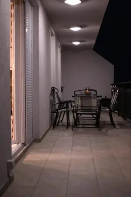 a patio with chairs and a table in a room at Loft 43 in Stara Pazova