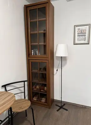 a dining room with a glass cabinet and a lamp at Lilly's Apartment in Belgrade