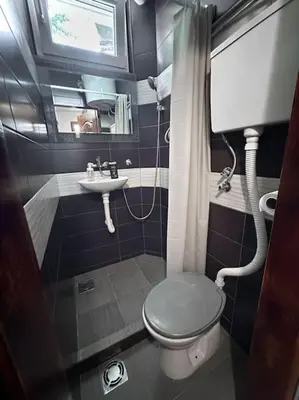 a small bathroom with a toilet and a sink at Lilly's Apartment in Belgrade
