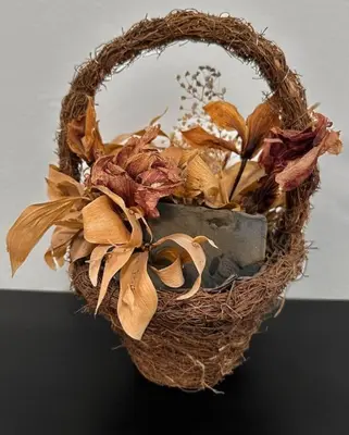 a wicker basket filled with dried leaves and a mirror at Lilly's Apartment in Belgrade
