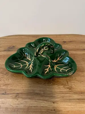 a green plate sitting on top of a wooden table at Lilly's Apartment in Belgrade