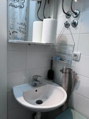 a bathroom with a sink and a mirror and towels at Surya in Belgrade