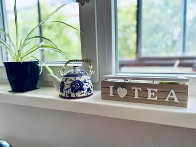 a window sill with a tea pot and a sign at Surya in Belgrade