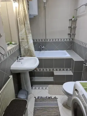 a bathroom with a sink and a tub and a toilet at Njegoševa Presidential Suite Vračar in Belgrade