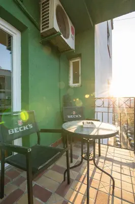 a patio with two chairs and a table on a balcony at Njegoševa Presidential Suite Vračar in Belgrade