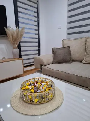 a living room with a bowl of fruit on a table at Gala Lux Lazarevac in Lazarevac