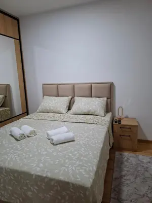 a bedroom with a bed with two towels on it at Gala Lux Lazarevac in Lazarevac