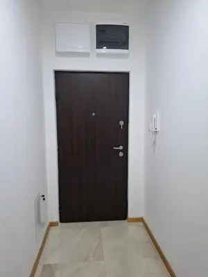 a brown door in a white room with at Gala Lux Lazarevac in Lazarevac
