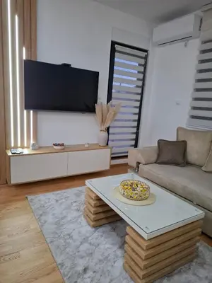 a living room with a couch and a coffee table at Gala Lux Lazarevac in Lazarevac