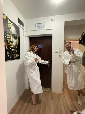a man and woman in white robes standing in a room at Leyla Lux in Bele Vode