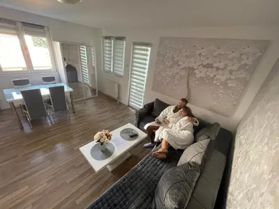 a man sitting on a couch in a living room at Leyla Lux in Bele Vode