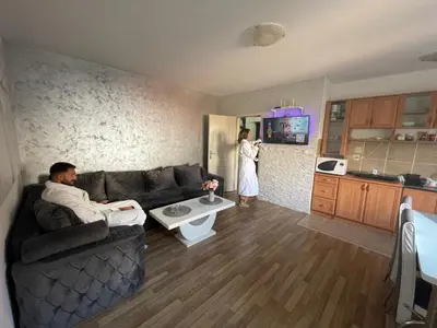 a man sitting on a couch in a living room at Leyla Lux in Bele Vode