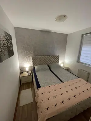 a bedroom with a bed with a comforter on it at Leyla Lux in Bele Vode